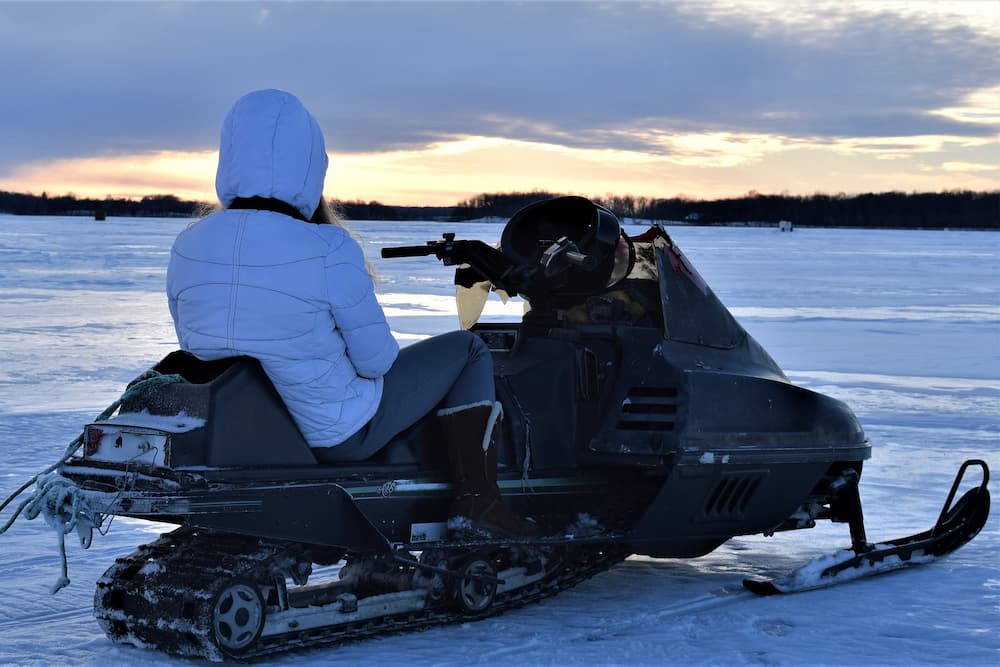 lady sitting on snowmobile